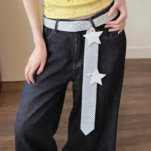 Close-up detail of a white polka dot narrow silk scarf used as a decorative belt with stars