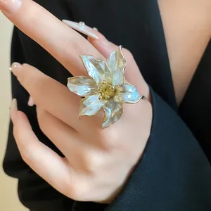 Close-up of a vintage tulip flower ring with pearl luster and golden edges on hand
