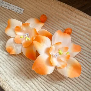 Macro detail of orange raffia fabric flower earrings with realistic floral petals