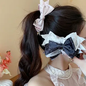 Elegant Korean style polka dot bow hair clips for women, stylish fabric hair accessories.