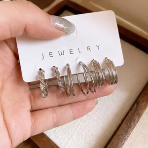 Premium silver geometric hoop earrings set featuring pleated and twisted metal textures