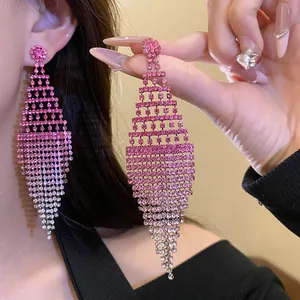 Detail of pink gradient rhinestone tassel earrings in a stylish rhombus design