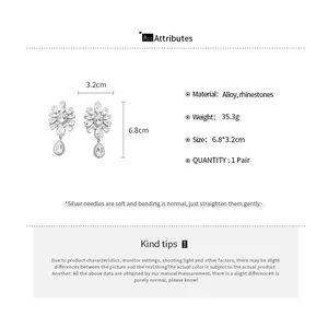 Detailed view of floral rhinestone earrings with measurements and material specifications