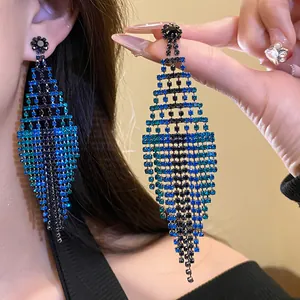 Close-up of blue and black gradient rhinestone rhombus fringe statement earrings.