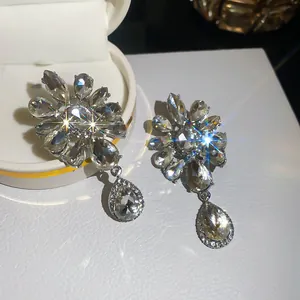Close-up of elegant crystal flower teardrop clip-on earrings with sparkle effect