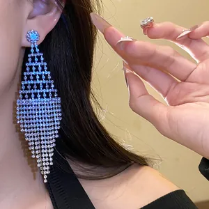 Close-up of sparkling rhinestone tassel earrings on model showcasing elegant jewelry details