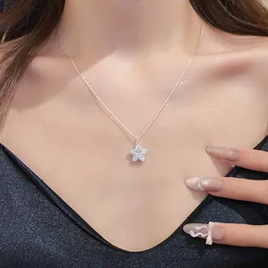 Detailed view of an elegant zircon star pendant necklace worn by a female model on a black dress