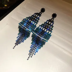 Detailed macro view showing the sparkling blue rhinestone gradient of these tassel earrings