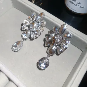 Detailed view of crystal flower teardrop clip-on earrings showing front and back