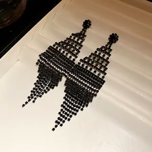 Close-up of elegant black rhinestone rhombus tassel earrings with shimmering details