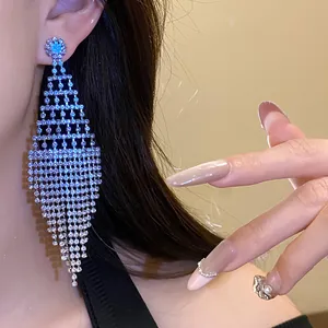 Detailed shot of sparkling rhinestone tassel earrings in a diamond shape