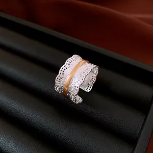 Close-up of the exquisite vintage hollow lace metal open ring with gold band detail