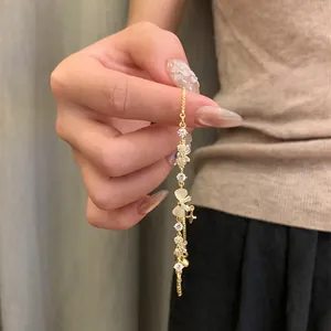 Close-up of 18K gold plated zircon butterfly bow and star adjustable bracelet
