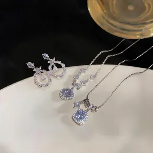 Elegant silver-toned jewelry set with zircon teardrop earrings and square pendant necklace