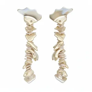Bohemian irregular shell tassel earrings with long gold drop elements on white background.