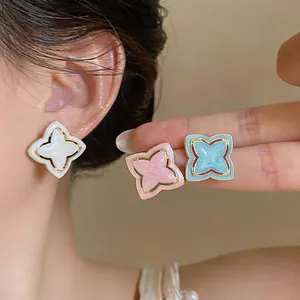 Elegant enamel star flower stud earrings in white, pink and blue pastel colors.