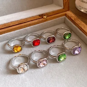 Vintage square gemstone open rings in multiple colors displayed in a box