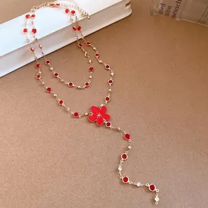 Elegant gold necklace with red flower pendant and rhinestone accents for women