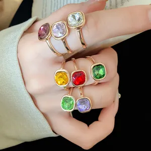 Close-up of elegant retro square rhinestone open rings in multiple colors on a hand
