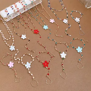 Detailed view of colorful resin flower necklaces and matching hand harness bracelets.