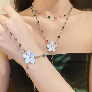 Floral resin necklace and bracelet set with colorful rhinestones on female model