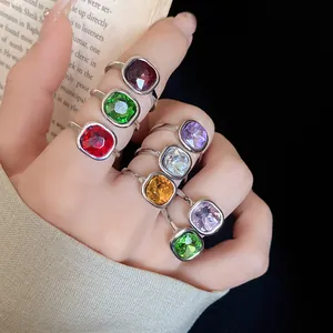 Detailed view of vintage square crystal rings set in silver with adjustable band.