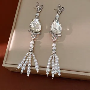 Vintage silver needle earrings featuring water-drop crystals and elegant pearl tassels