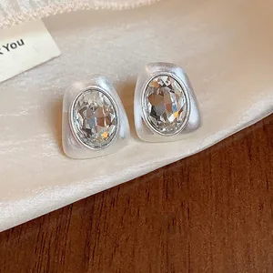 Elegant irregular geometric silver stud earrings with inlaid oval clear crystal stones