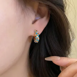 Elegant French retro turquoise and crystal intertwined gold hoop earrings on model