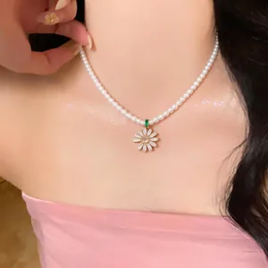 Elegant 18k gold plated daisy flower pendant on a dainty pearl necklace choker