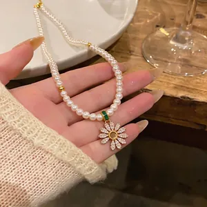 Elegant 18k gold plated pearl necklace featuring a sparkling zircon daisy pendant