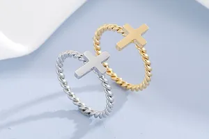 Minimalist twisted stainless steel rings with cross motif in silver and gold finish