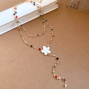 Detail of a multi-colored floral necklace with resin petals and vibrant crystal accents.