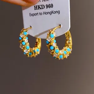 Elegant vintage gold hoop earrings featuring turquoise and sparkling clear stones detail