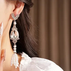 Close-up of luxury vintage rhinestone teardrop earrings with elegant pearl tassels