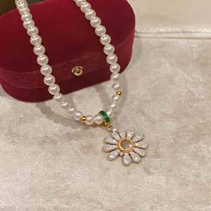 Elegant 18k gold plated pearl necklace with sparkling zircon flower pendant detail