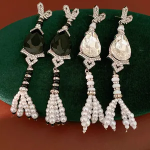 Close-up of luxury vintage water drop tassel pearl earrings with sparkling rhinestones