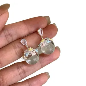 Elegant silver drop earrings with floral resin sphere and sparkly teardrop crystal