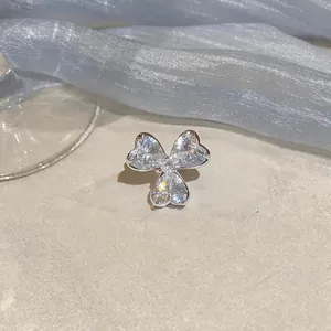 Macro detail of zircon flower ear clip featuring heart-shaped stones in silver finish