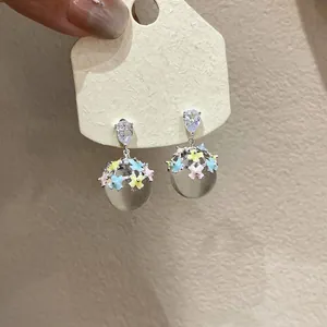Exquisite close-up of resin ball drop earrings featuring vibrant colorful floral enamel details