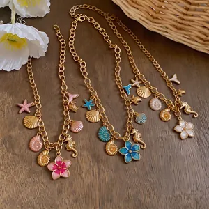 Gold chain necklaces featuring colorful enamel sea shell seahorse and flower pendants