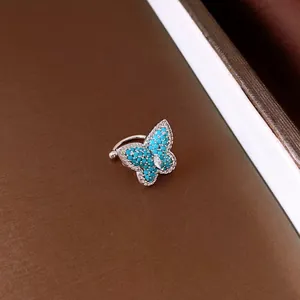 Detailed view of a turquoise butterfly ear cuff featuring sparkling marquise cut zircon stones