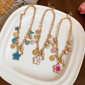 Detailed view of beach-themed necklaces with seashell, seahorse, and flower pendants.