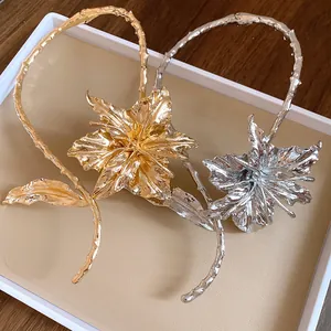 Close-up of gold and silver wrinkled flower metal chokers with textured petals.