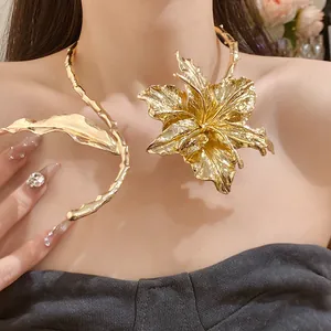 Close-up of a bold gold metallic flower choker with textured leaf details on model