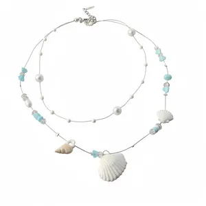 Elegant double-strand summer ocean necklace featuring blue accents, shells and pearls.