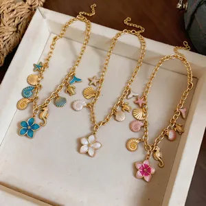 Detail view of beach style necklaces with shell seahorse and flower charms