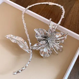 Close-up of elegant silver metal flower choker with pleated leaf design