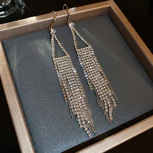 Close-up view of elegant silver-tone rhinestone tassel dangle earrings in a gift box