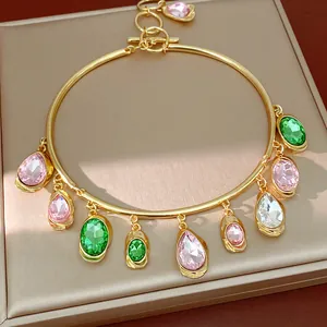Detailed close-up of a gold-tone choker featuring multi-colored water drop rhinestone charms